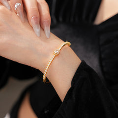 Elegant open bangle in gold with sparkling zircon stones and a marquise centerpiece, light-luxury adjustable bracelet.