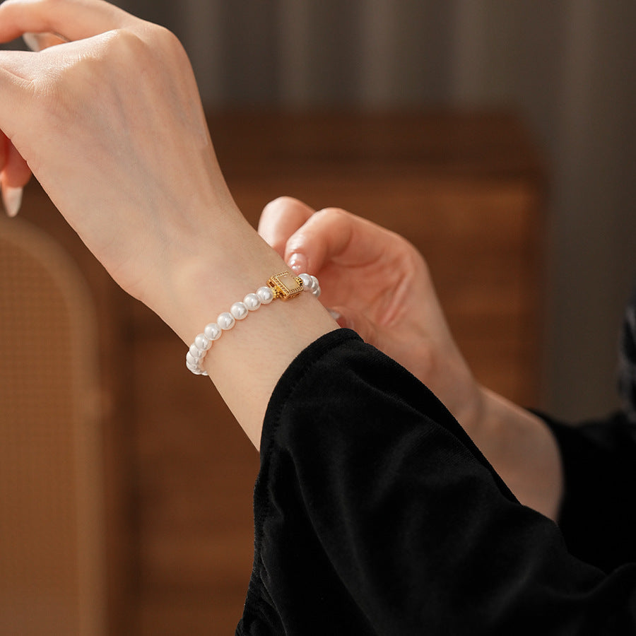 Blush Square Pearl Bracelet, a bracelet featuring lustrous pearls and a pale pink square zircon pendant.