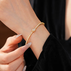 Elegant open bangle in gold with sparkling zircon stones and a marquise centerpiece, light-luxury adjustable bracelet.
