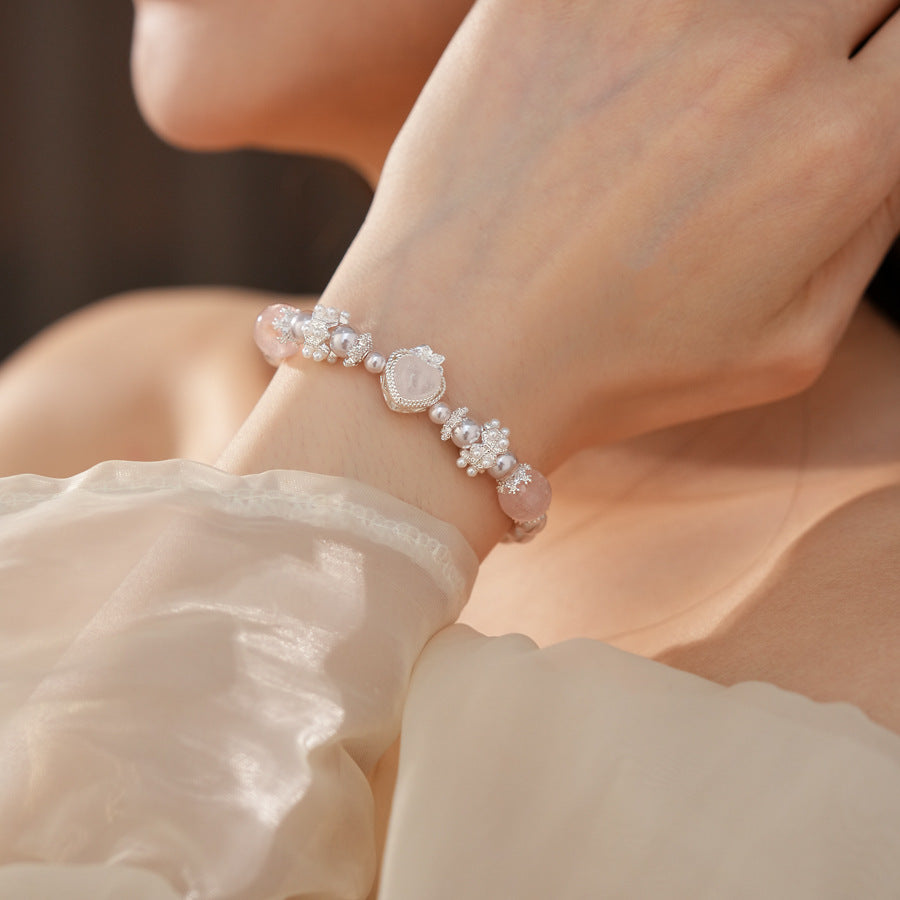 Rosy Heart Pearl Bracelet with pink crystal heart charm and luminous pearls on black background