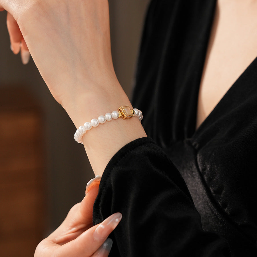 Blush Square Pearl Bracelet, a bracelet featuring lustrous pearls and a pale pink square zircon pendant.