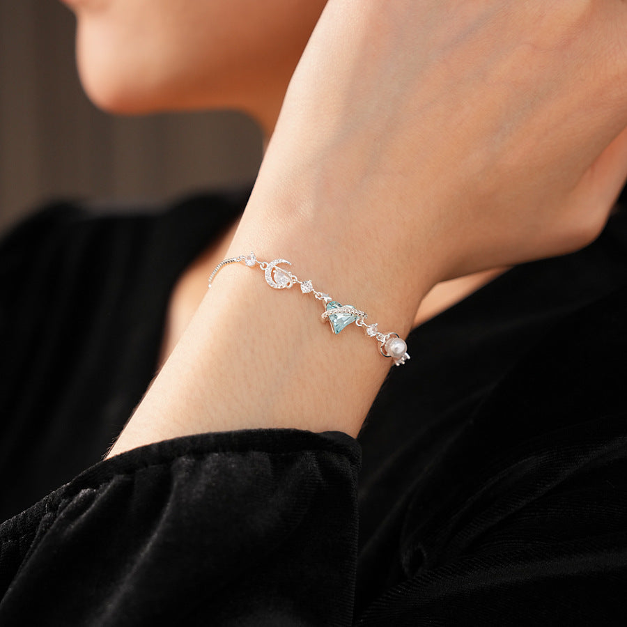 Aqua Moon Charm Bracelet with blue heart zircon, moon and star charms, and pearl detail – Glazenya jewelry