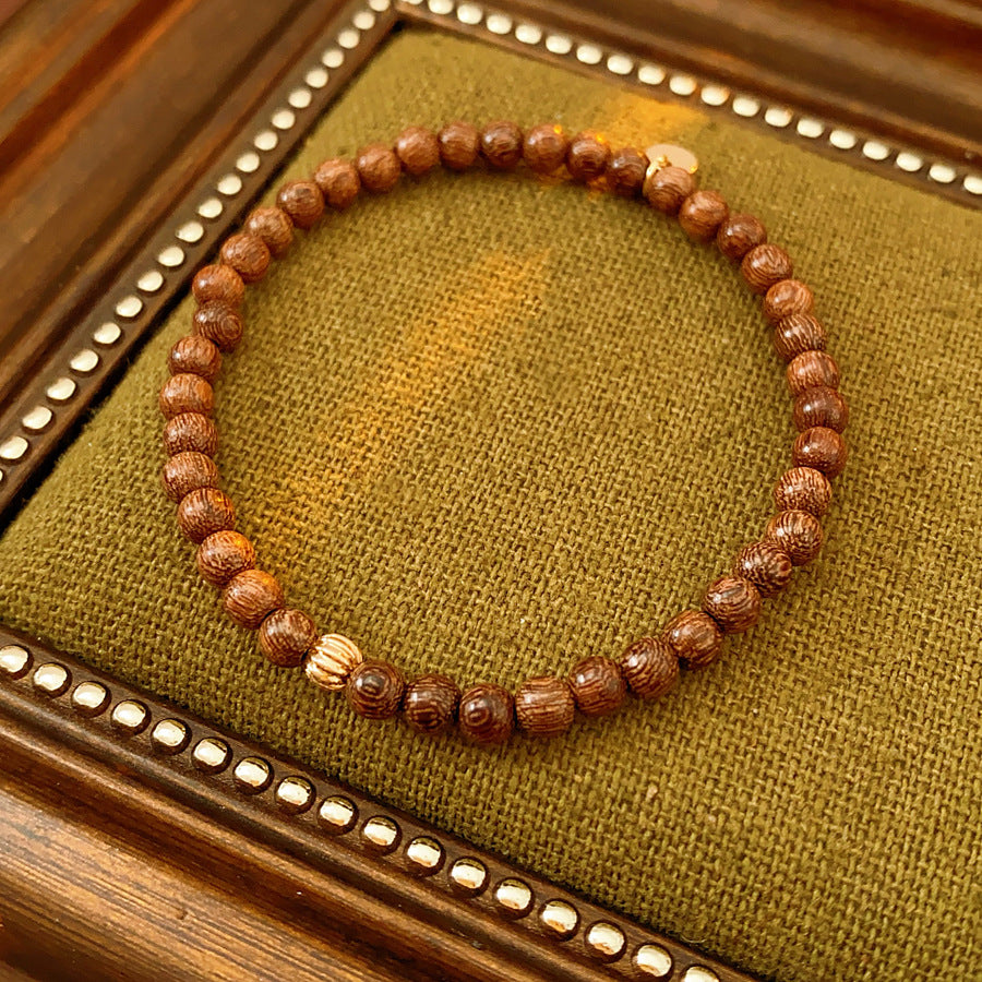 Wood-grain beaded bracelet with small gold-tone copper accent — Woodgrain Whisper Bracelet by Glazenya.