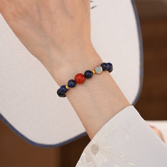 Lapis lazuli beaded bracelet with red accent bead and gold spacers — Midnight Sun Lapis Bracelet by Glazenya.