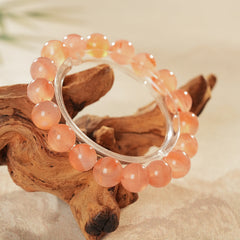 Peach-toned natural red agate beaded bangle with glossy round stones — Peach Glow Agate Bangle.