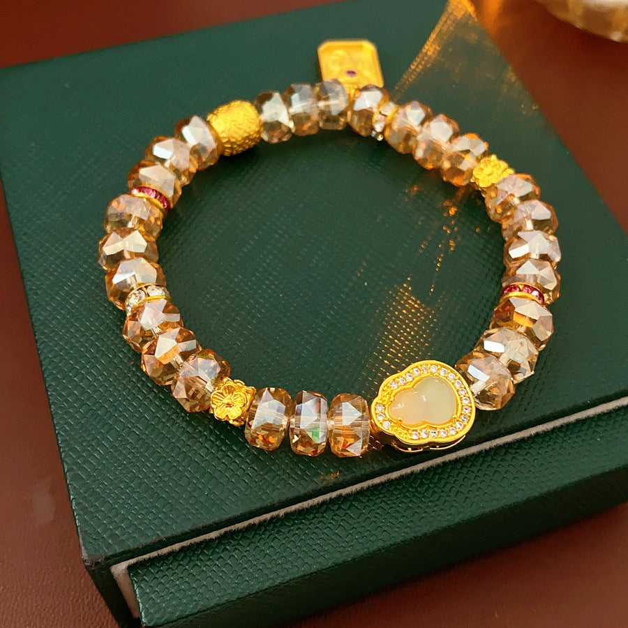 Faceted champagne crystal beaded bracelet with gold-tone pavé gourd charm — Champagne Crystal Gourd Charm Bracelet.