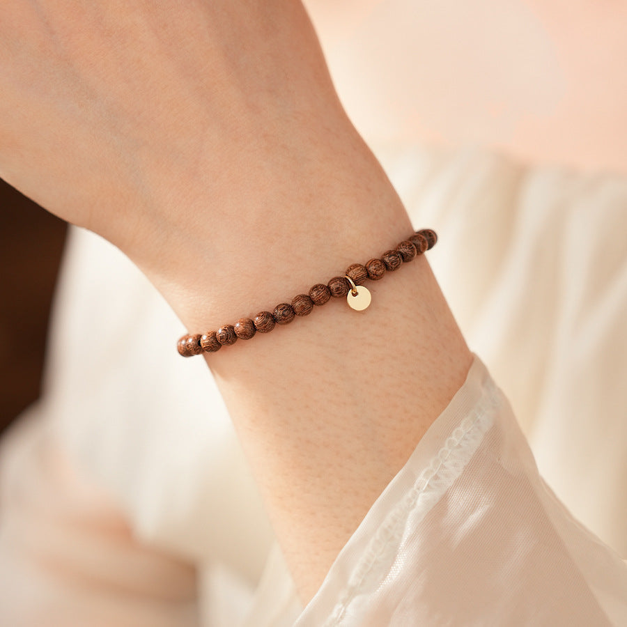 Wood-grain beaded bracelet with small gold-tone copper accent — Woodgrain Whisper Bracelet by Glazenya.