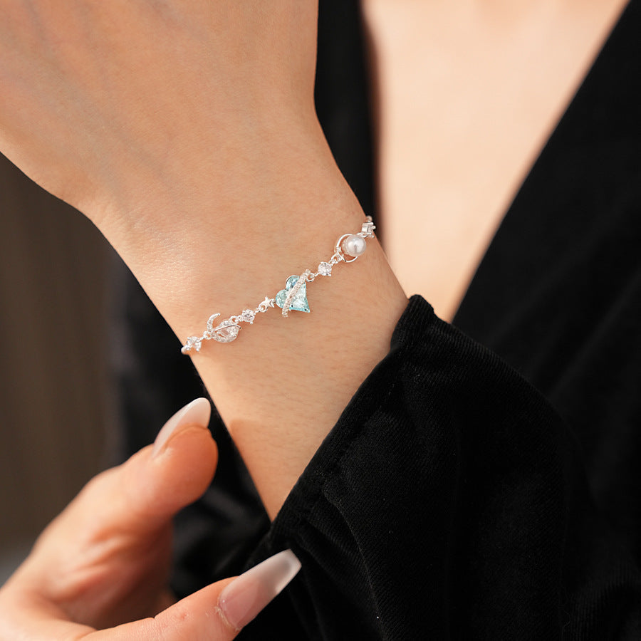 Aqua Moon Charm Bracelet with blue heart zircon, moon and star charms, and pearl detail – Glazenya jewelry