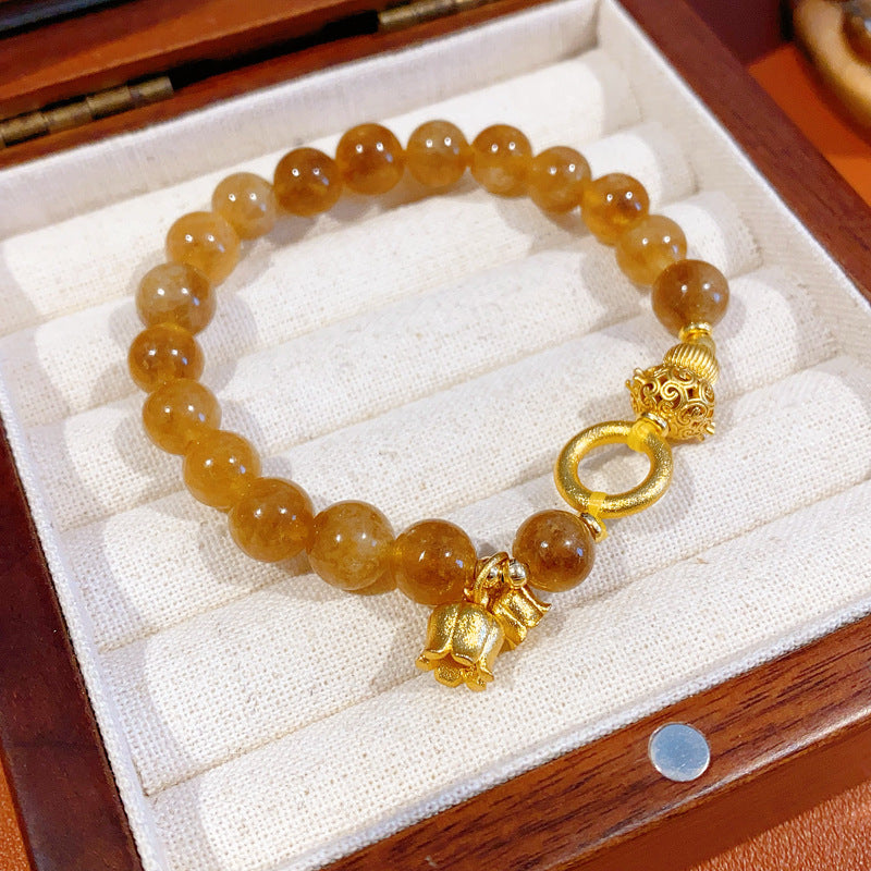 Gold-tone beaded bracelet with lotus charm and zircon accents — Golden Lotus Prosperity Bracelet by Glazenya.