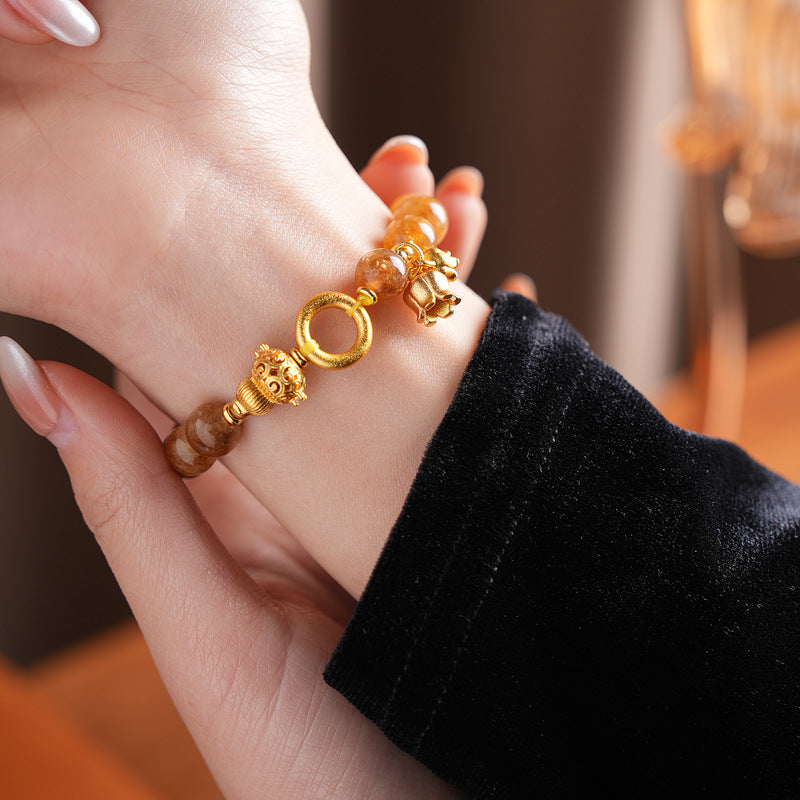 Gold-tone beaded bracelet with lotus charm and zircon accents — Golden Lotus Prosperity Bracelet by Glazenya.