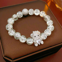 Clear crackle-glass beaded bracelet with pavé bear charm holding a heart — Glacial Heart Bear Bracelet.