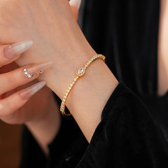 Elegant open bangle in gold with sparkling zircon stones and a marquise centerpiece, light-luxury adjustable bracelet.