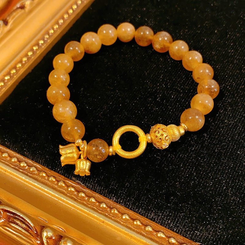 Gold-tone beaded bracelet with lotus charm and zircon accents — Golden Lotus Prosperity Bracelet by Glazenya.