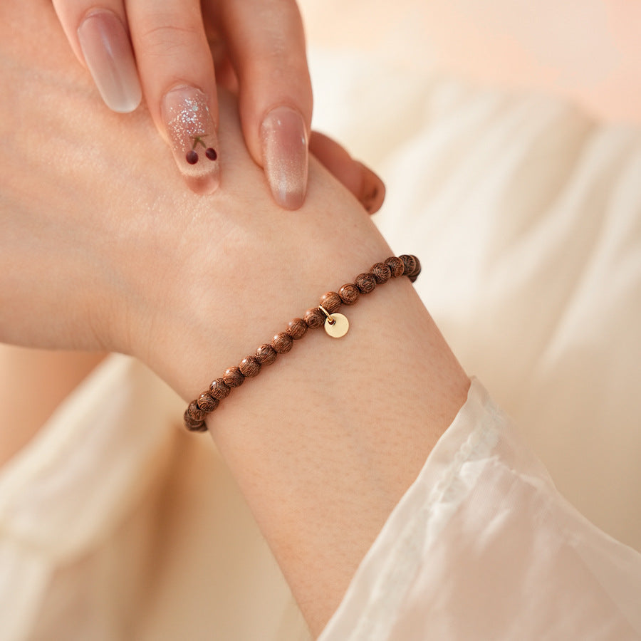 Wood-grain beaded bracelet with small gold-tone copper accent — Woodgrain Whisper Bracelet by Glazenya.