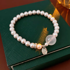 Shijia pearl beaded bracelet with crystal orb focal, zircon spacer and silver-tone coin charm — Moonlit Pearl Charm Bracelet.