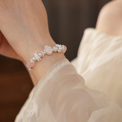 Rosy Heart Pearl Bracelet with pink crystal heart charm and luminous pearls on black background