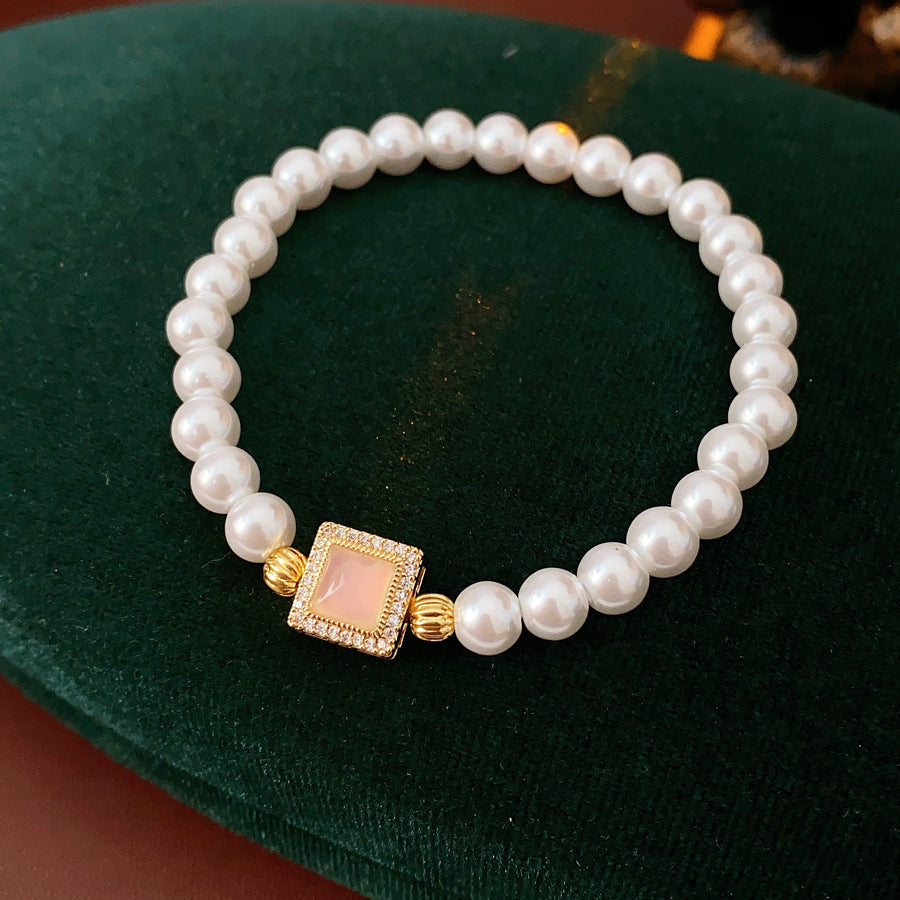 Blush Square Pearl Bracelet, a bracelet featuring lustrous pearls and a pale pink square zircon pendant.