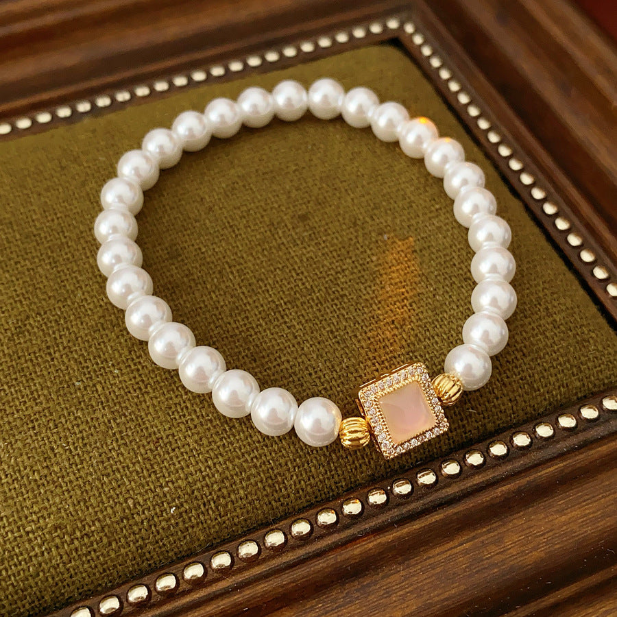 Blush Square Pearl Bracelet, a bracelet featuring lustrous pearls and a pale pink square zircon pendant.