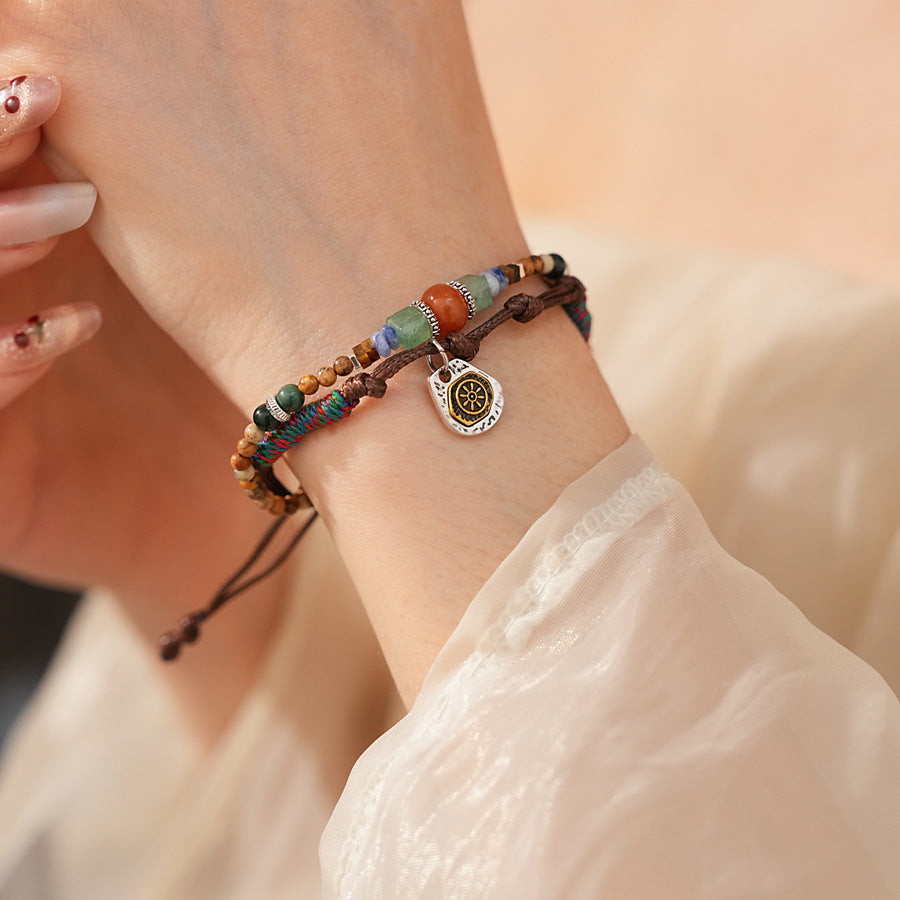 Tribal Harmony Woven Bracelet with natural stone beads, colorful woven threads, and symbolic charm in bohemian style