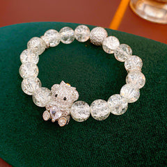 Clear crackle-glass beaded bracelet with pavé bear charm holding a heart — Glacial Heart Bear Bracelet.