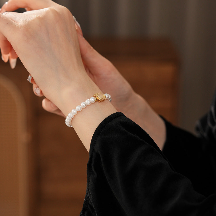 Blush Square Pearl Bracelet, a bracelet featuring lustrous pearls and a pale pink square zircon pendant.