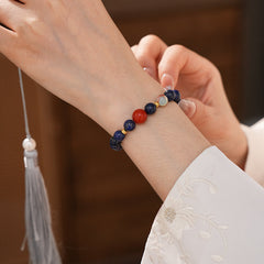 Lapis lazuli beaded bracelet with red accent bead and gold spacers — Midnight Sun Lapis Bracelet by Glazenya.