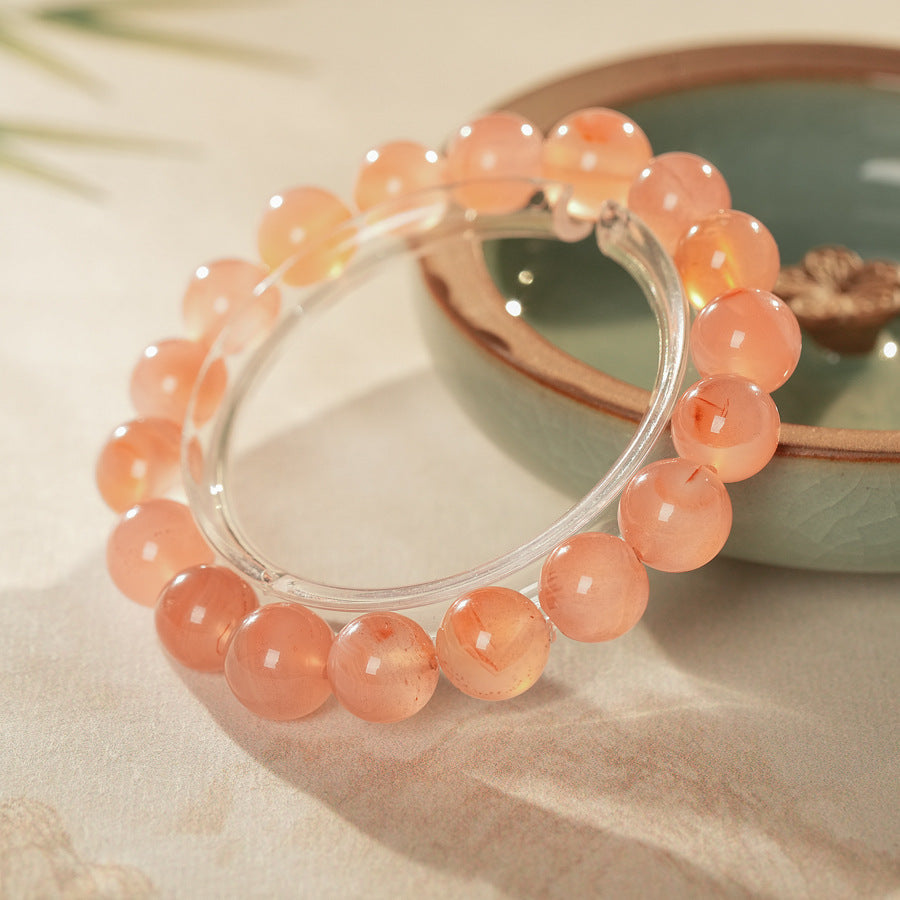 Peach-toned natural red agate beaded bangle with glossy round stones — Peach Glow Agate Bangle.