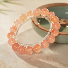Peach-toned natural red agate beaded bangle with glossy round stones — Peach Glow Agate Bangle.
