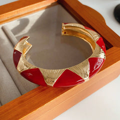 Gold-tone open cuff with triangular glossy enamel peaks; three variants (black, white, red) — Harlequin Enamel Cuff.