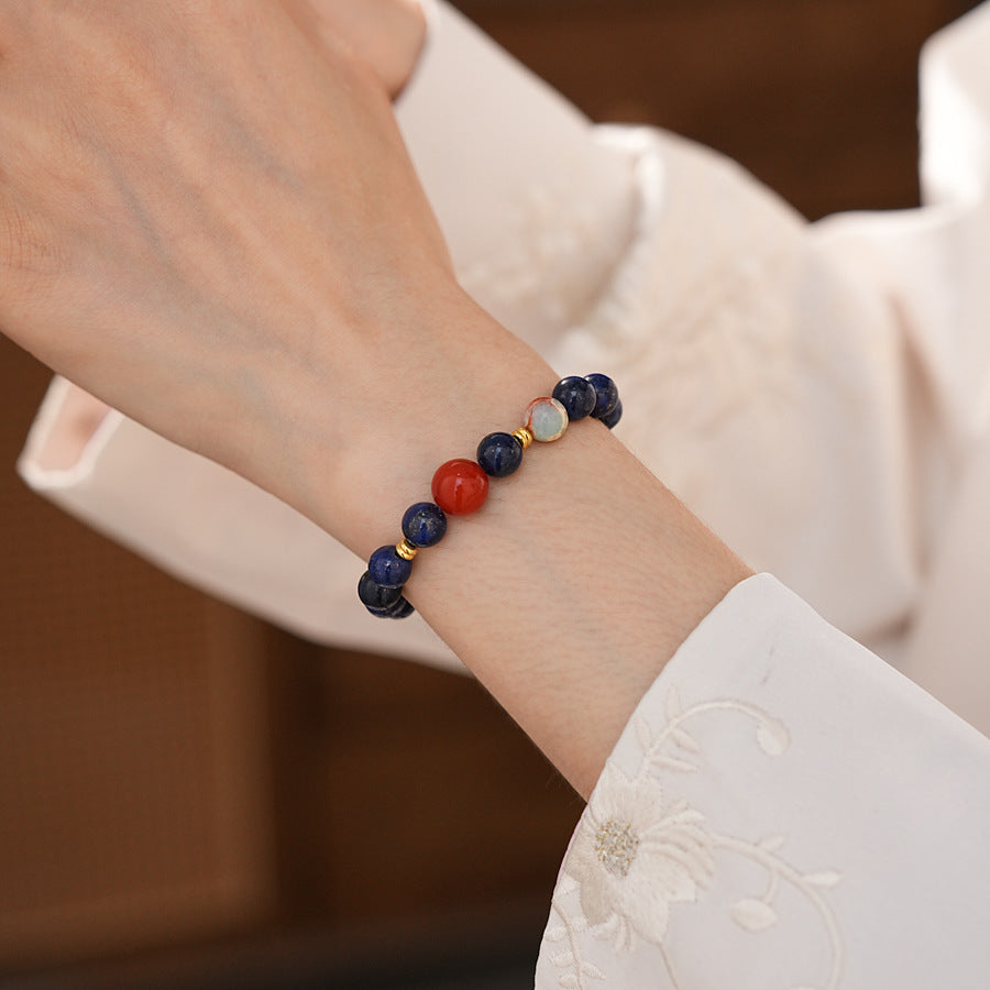Lapis lazuli beaded bracelet with red accent bead and gold spacers — Midnight Sun Lapis Bracelet by Glazenya.