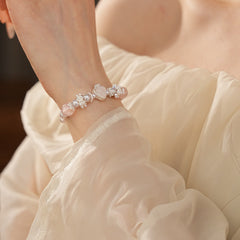 Rosy Heart Pearl Bracelet with pink crystal heart charm and luminous pearls on black background