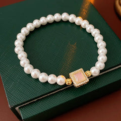 Blush Square Pearl Bracelet, a bracelet featuring lustrous pearls and a pale pink square zircon pendant.