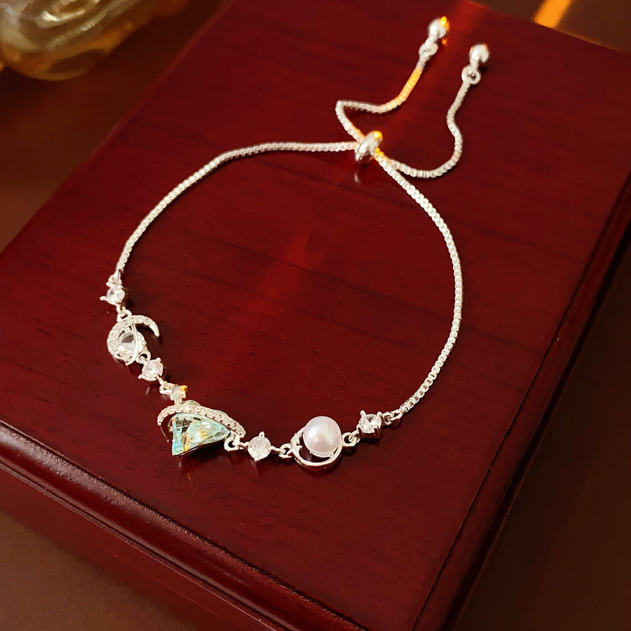 Aqua Moon Charm Bracelet with blue heart zircon, moon and star charms, and pearl detail – Glazenya jewelry