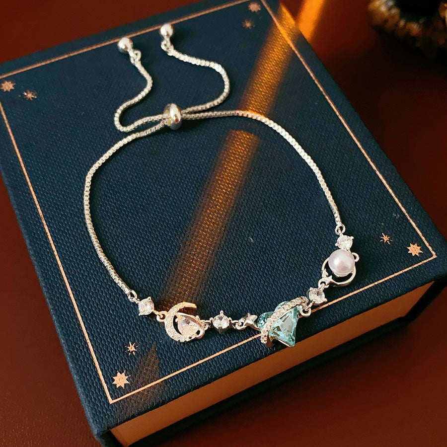 Aqua Moon Charm Bracelet with blue heart zircon, moon and star charms, and pearl detail – Glazenya jewelry