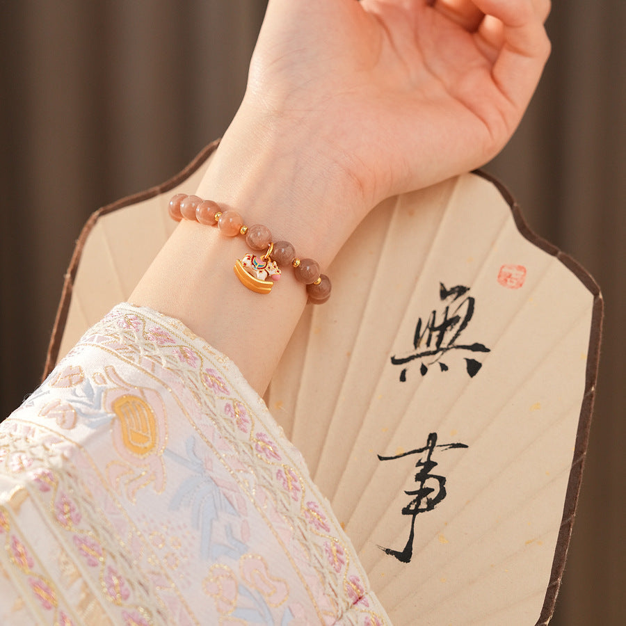Peach sunstone beaded bracelet with a small gold-tone rocking horse charm — Sunstone Rocking Horse Bracelet by Glazenya.