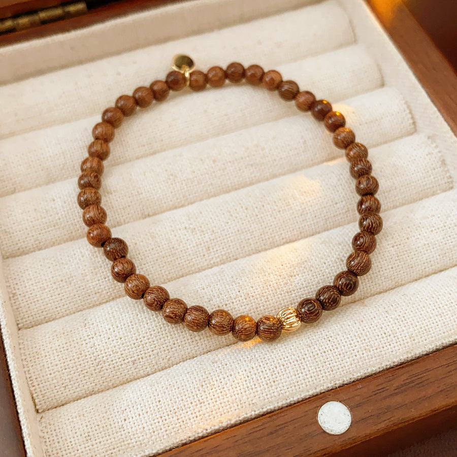 Wood-grain beaded bracelet with small gold-tone copper accent — Woodgrain Whisper Bracelet by Glazenya.
