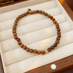 Wood-grain beaded bracelet with small gold-tone copper accent — Woodgrain Whisper Bracelet by Glazenya.
