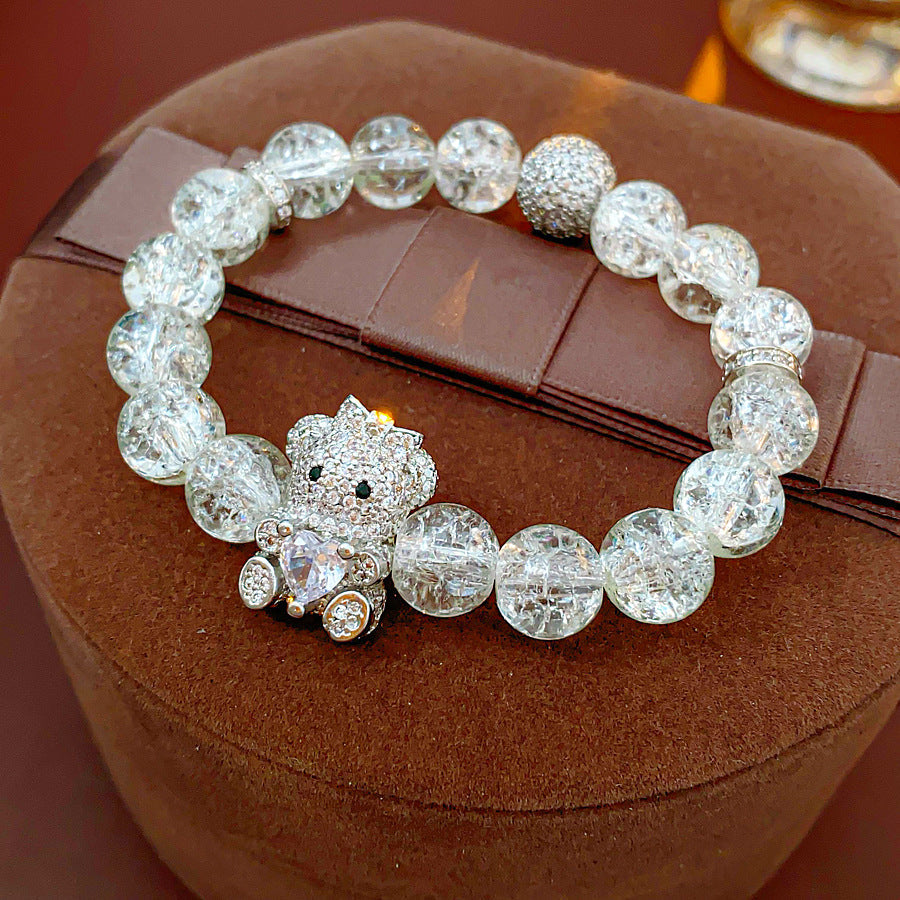 Clear crackle-glass beaded bracelet with pavé bear charm holding a heart — Glacial Heart Bear Bracelet.