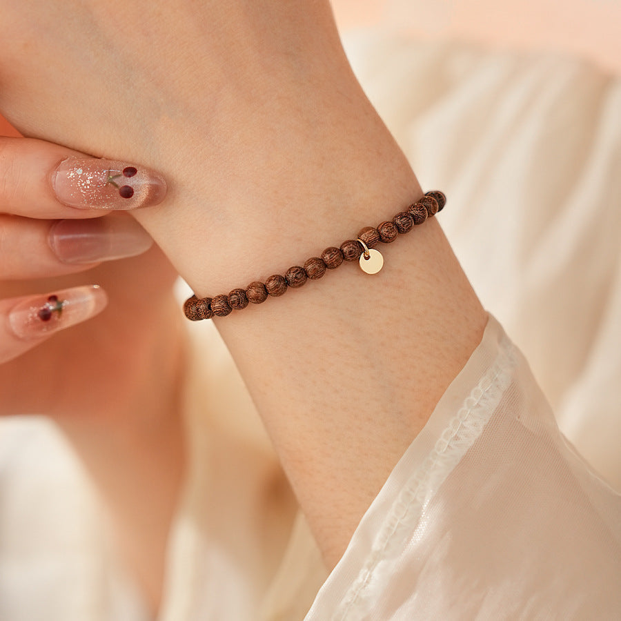 Wood-grain beaded bracelet with small gold-tone copper accent — Woodgrain Whisper Bracelet by Glazenya.