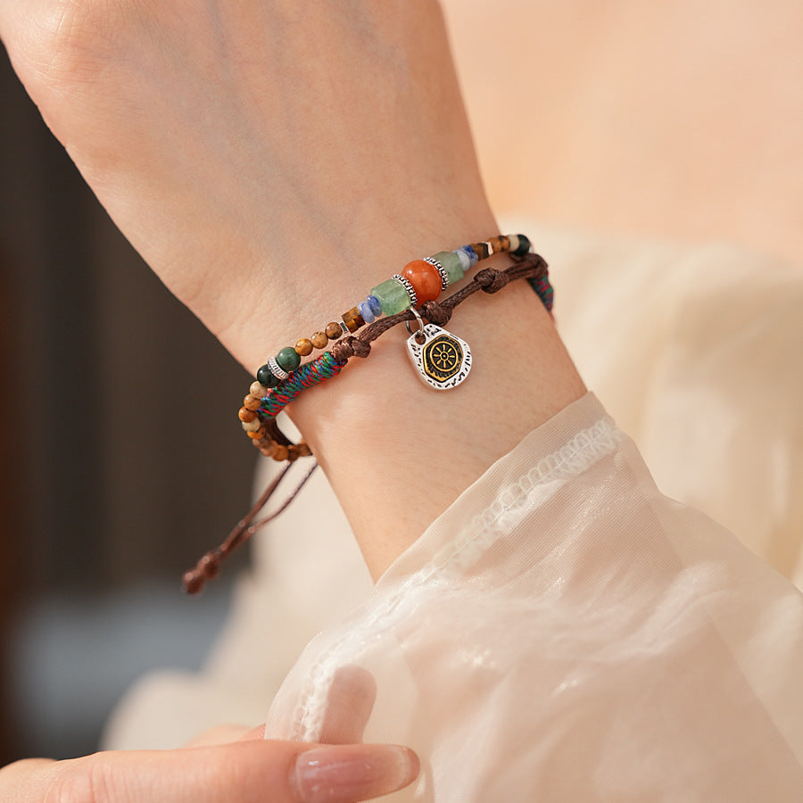 Tribal Harmony Woven Bracelet with natural stone beads, colorful woven threads, and symbolic charm in bohemian style