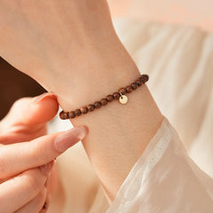 Wood-grain beaded bracelet with small gold-tone copper accent — Woodgrain Whisper Bracelet by Glazenya.