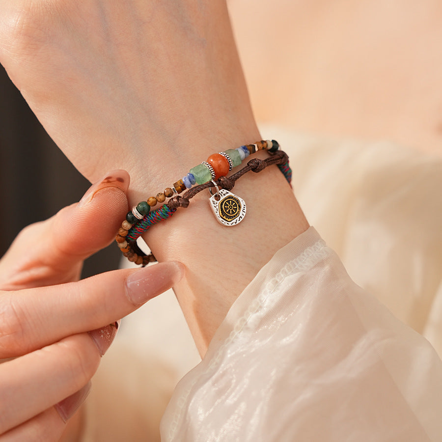 Tribal Harmony Woven Bracelet with natural stone beads, colorful woven threads, and symbolic charm in bohemian style