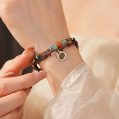 Tribal Harmony Woven Bracelet with natural stone beads, colorful woven threads, and symbolic charm in bohemian style