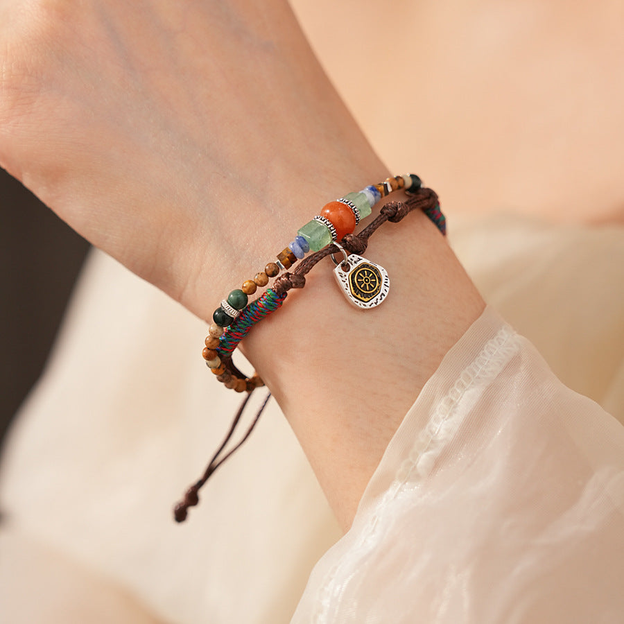 Tribal Harmony Woven Bracelet with natural stone beads, colorful woven threads, and symbolic charm in bohemian style
