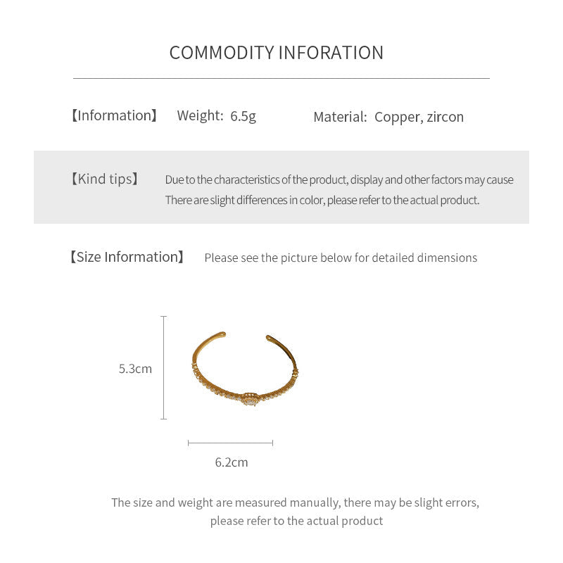 Elegant open bangle in gold with sparkling zircon stones and a marquise centerpiece, light-luxury adjustable bracelet.