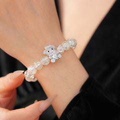 Clear crackle-glass beaded bracelet with pavé bear charm holding a heart — Glacial Heart Bear Bracelet.