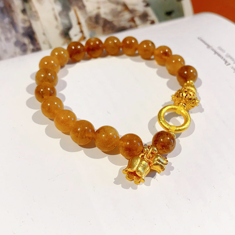 Gold-tone beaded bracelet with lotus charm and zircon accents — Golden Lotus Prosperity Bracelet by Glazenya.