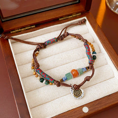 Tribal Harmony Woven Bracelet with natural stone beads, colorful woven threads, and symbolic charm in bohemian style